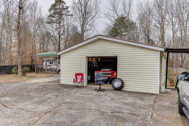 a view of a house with a large tree and a yard