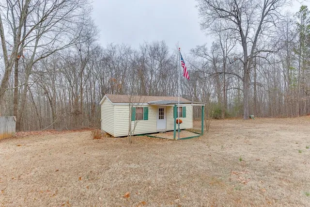 a view of a house with a yard covered in snow