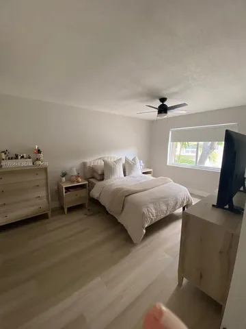 a bedroom with a bed and a tv
