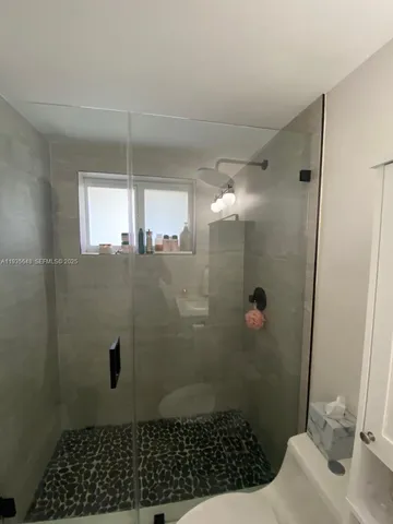 a bathroom with a sink toilet and mirror