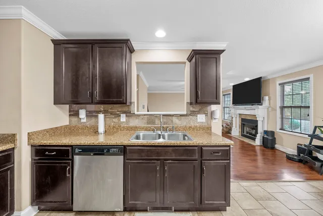 a kitchen with a sink appliances and cabinets