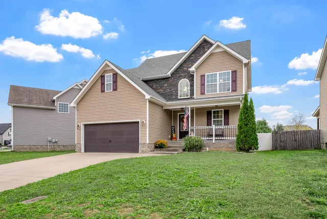 a front view of a house with a yard and garage