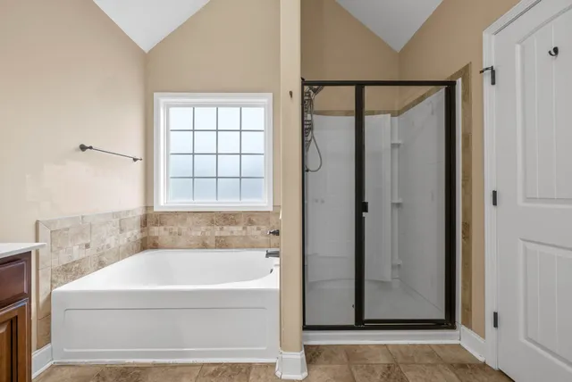 a bathroom with a bathtub and a shower