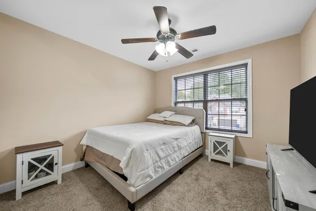 a bedroom with a bed and a tv