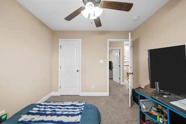 a bedroom with bed and a window