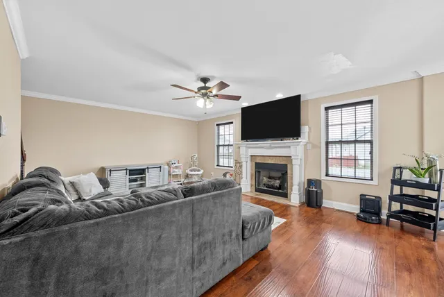 a living room with furniture fireplace and flat screen tv