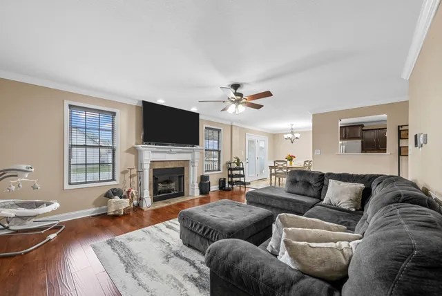 a living room with furniture a fireplace and a flat screen tv