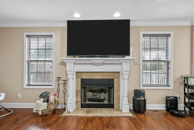 a living room with furniture a flat screen tv and a fireplace
