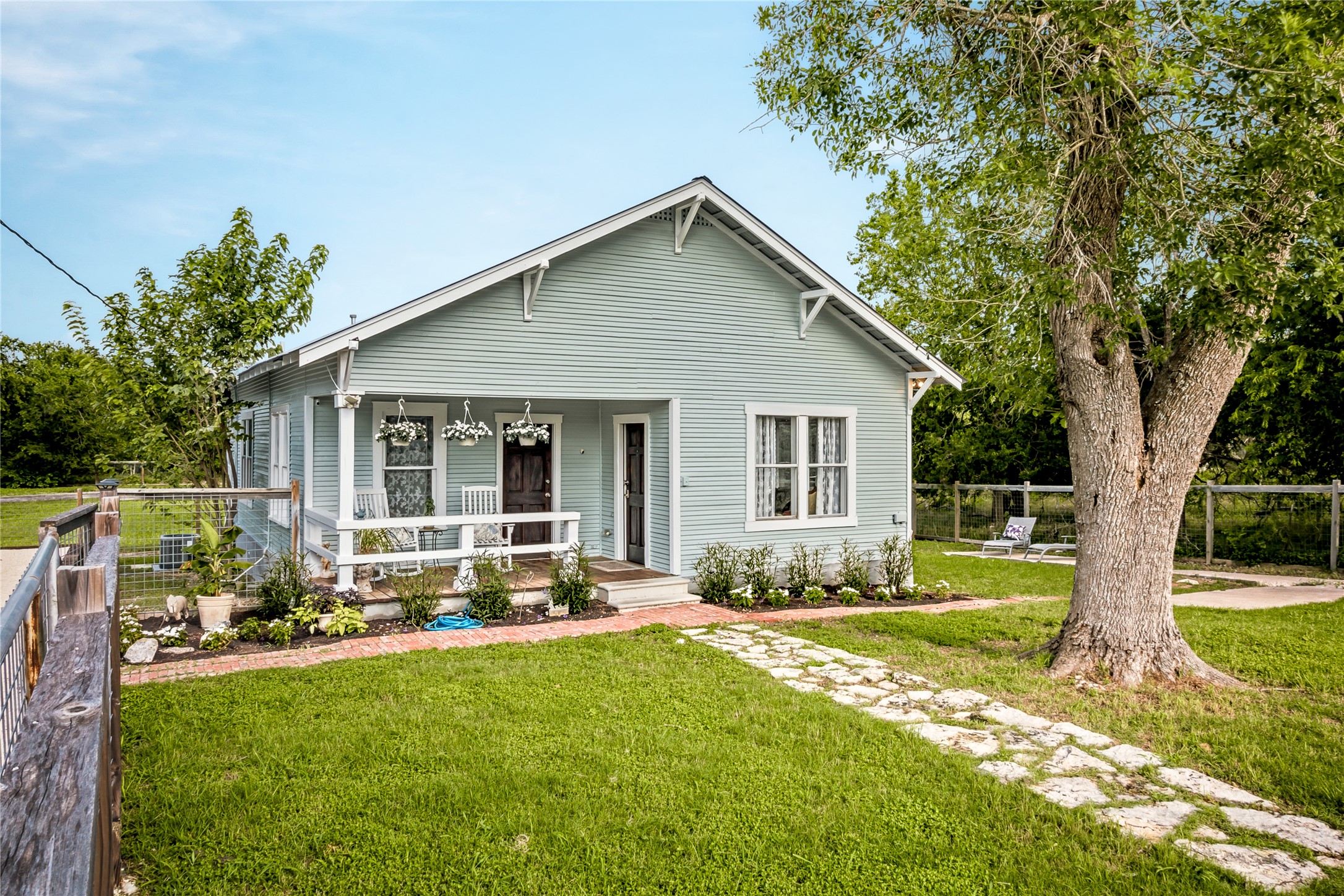372 Old Lockhart Road Lockhart, TX 78644 - Photo 7 of 40 A charming cottage facade featuring a welcoming porch and a meandering stone pathway.