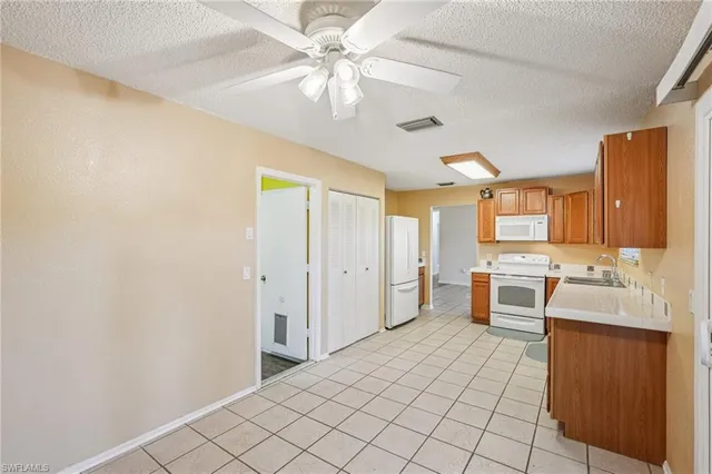 a kitchen with a stove sink and cabinets