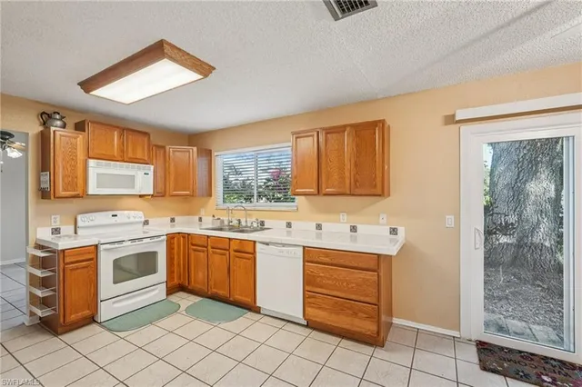 a kitchen with a sink stove and cabinets