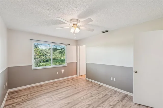 a view of a livingroom with a ceiling fan and wooden floor