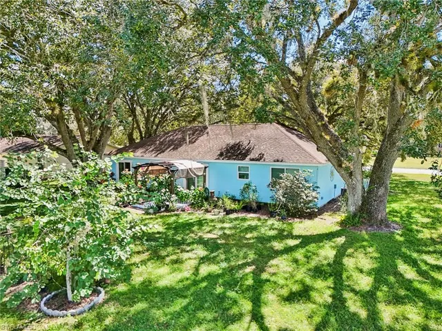 an aerial view of a residential houses with outdoor space