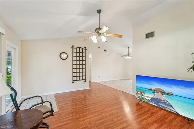 a view of a livingroom with workspace and a window