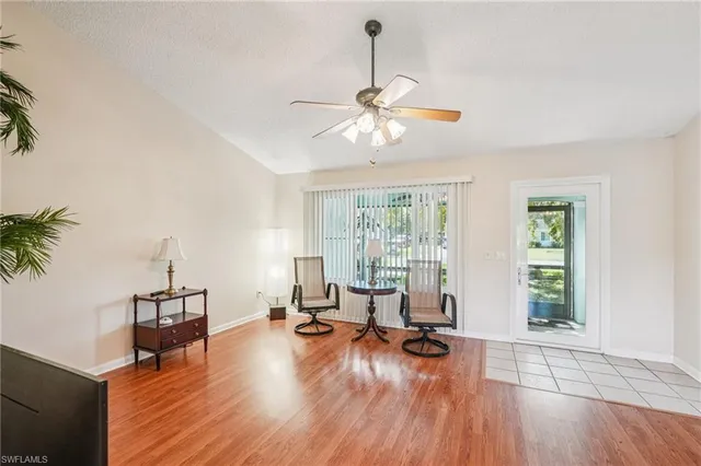 a view of a room with gym equipment and floor to ceiling window