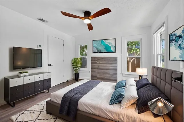 a bedroom with a bed lamps and window