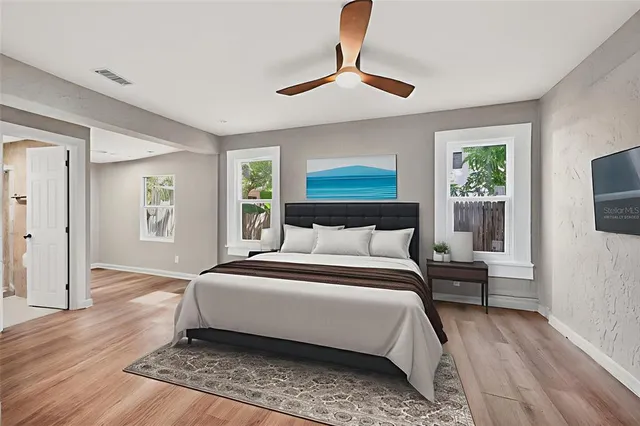 a bedroom with a large bed and a chandelier