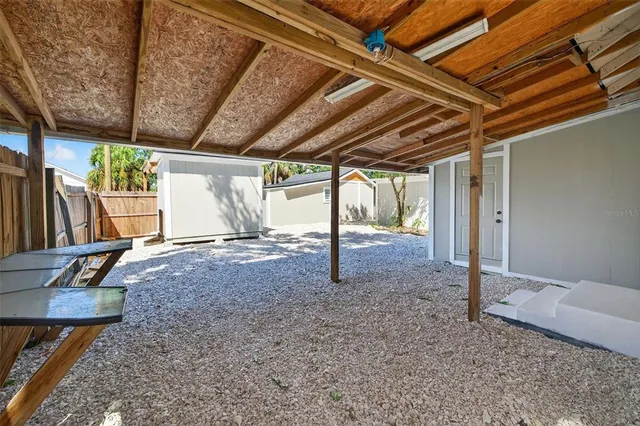 a view of a house with backyard and a tree
