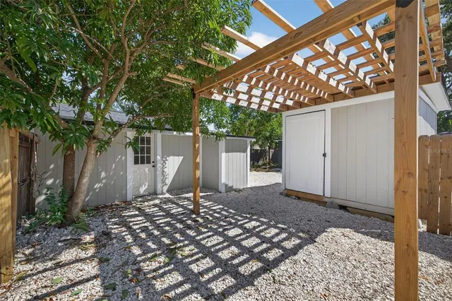 a view of a house with backyard and a tree