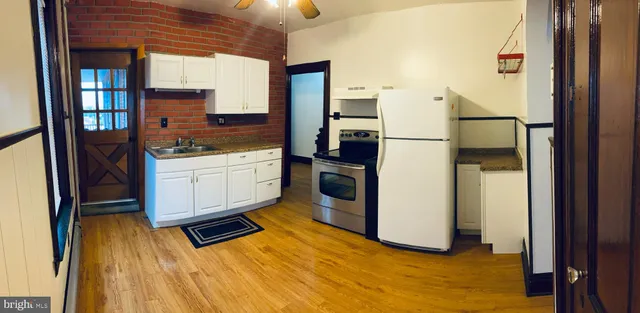 a kitchen with stainless steel appliances a refrigerator and a stove