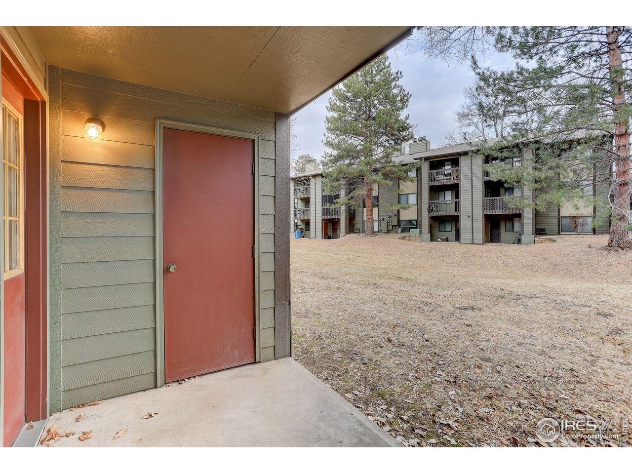 925 Columbia Road, Unit 716 Fort Collins, CO 80525 - Photo 14 of 17 a view of a house with a wooden fence