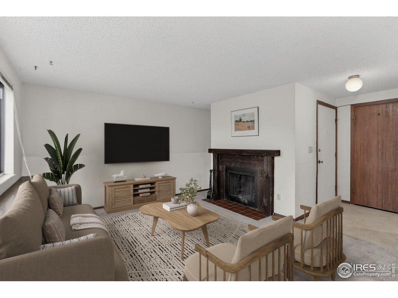 925 Columbia Road, Unit 716 Fort Collins, CO 80525 - Photo 3 of 17 a living room with furniture a fireplace and a flat screen tv