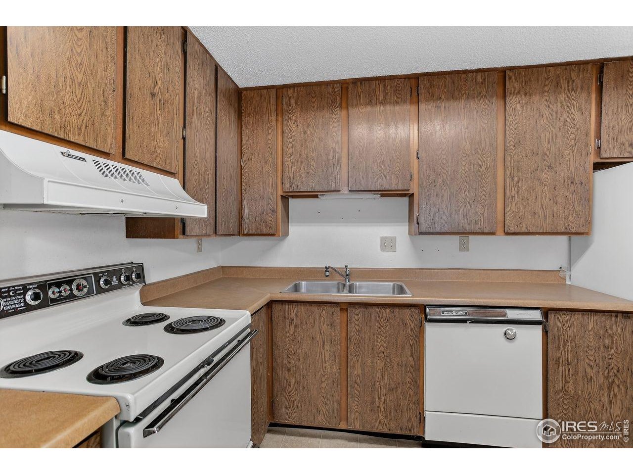 925 Columbia Road, Unit 716 Fort Collins, CO 80525 - Photo 5 of 17 a kitchen with a sink a stove and cabinets