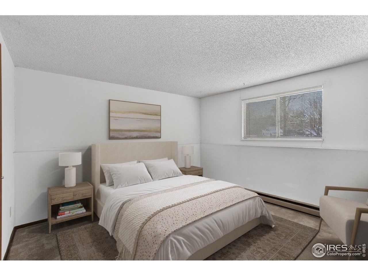 925 Columbia Road, Unit 716 Fort Collins, CO 80525 - Photo 8 of 17 a bedroom with a bed and a painting on the wall