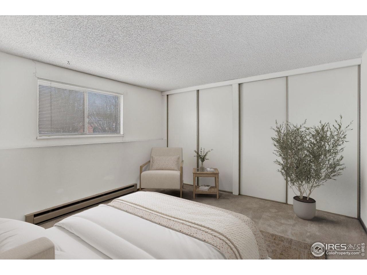 925 Columbia Road, Unit 716 Fort Collins, CO 80525 - Photo 9 of 17 a bedroom with a bed and a potted plant