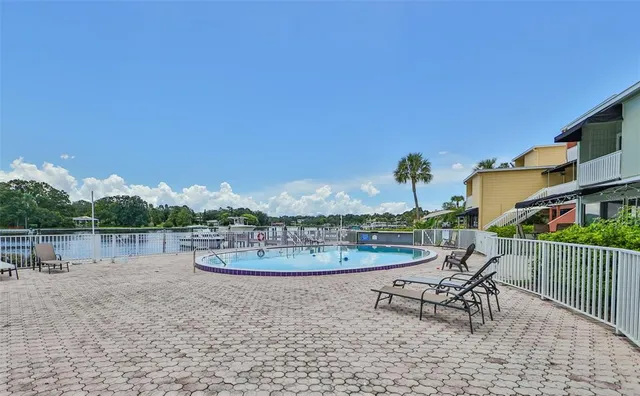 a view of a swimming pool with chairs