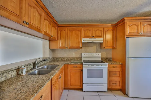 a kitchen with appliances cabinets and a window