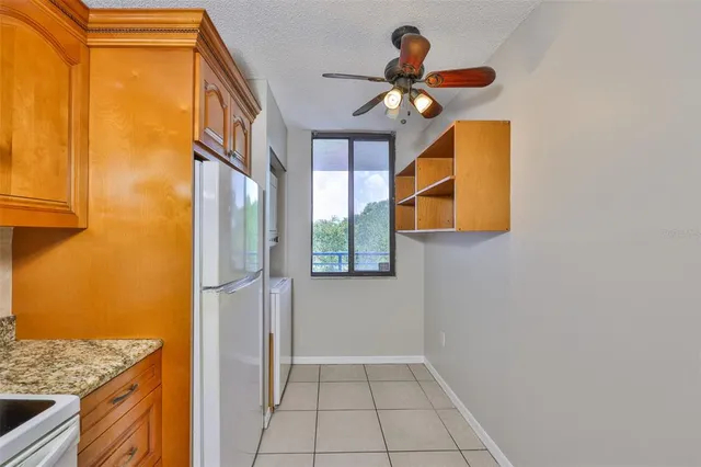 a kitchen with a refrigerator and countertop sink