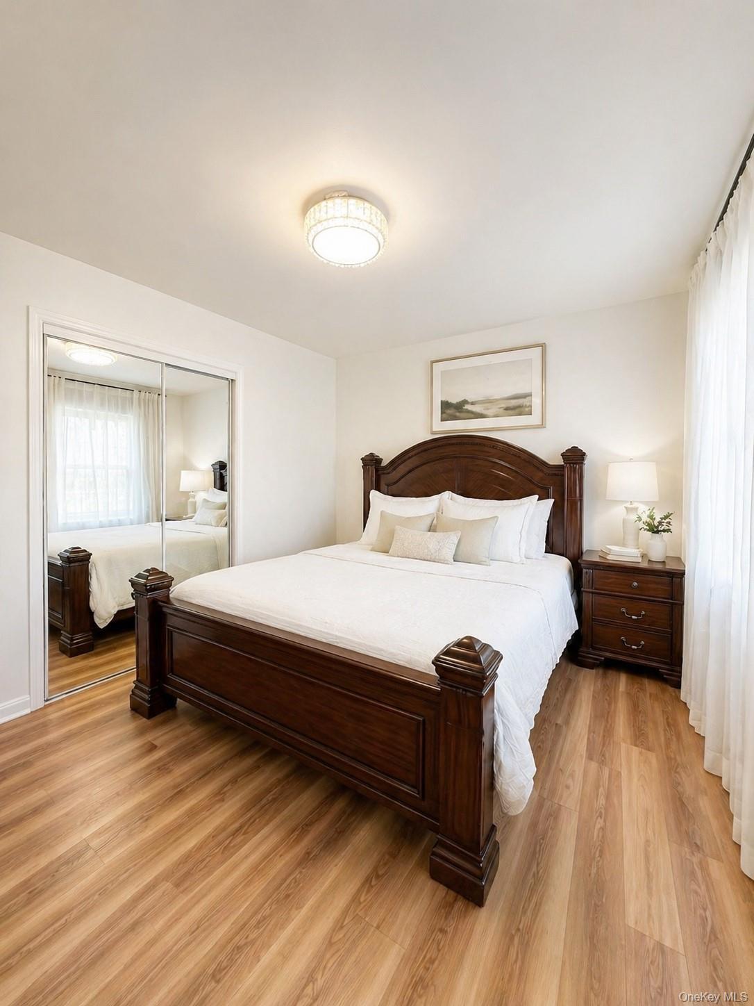 139-16 28th Road, Unit Z Queens, NY 11354 - Photo 3 of 14 a bedroom with a bed and wooden floor