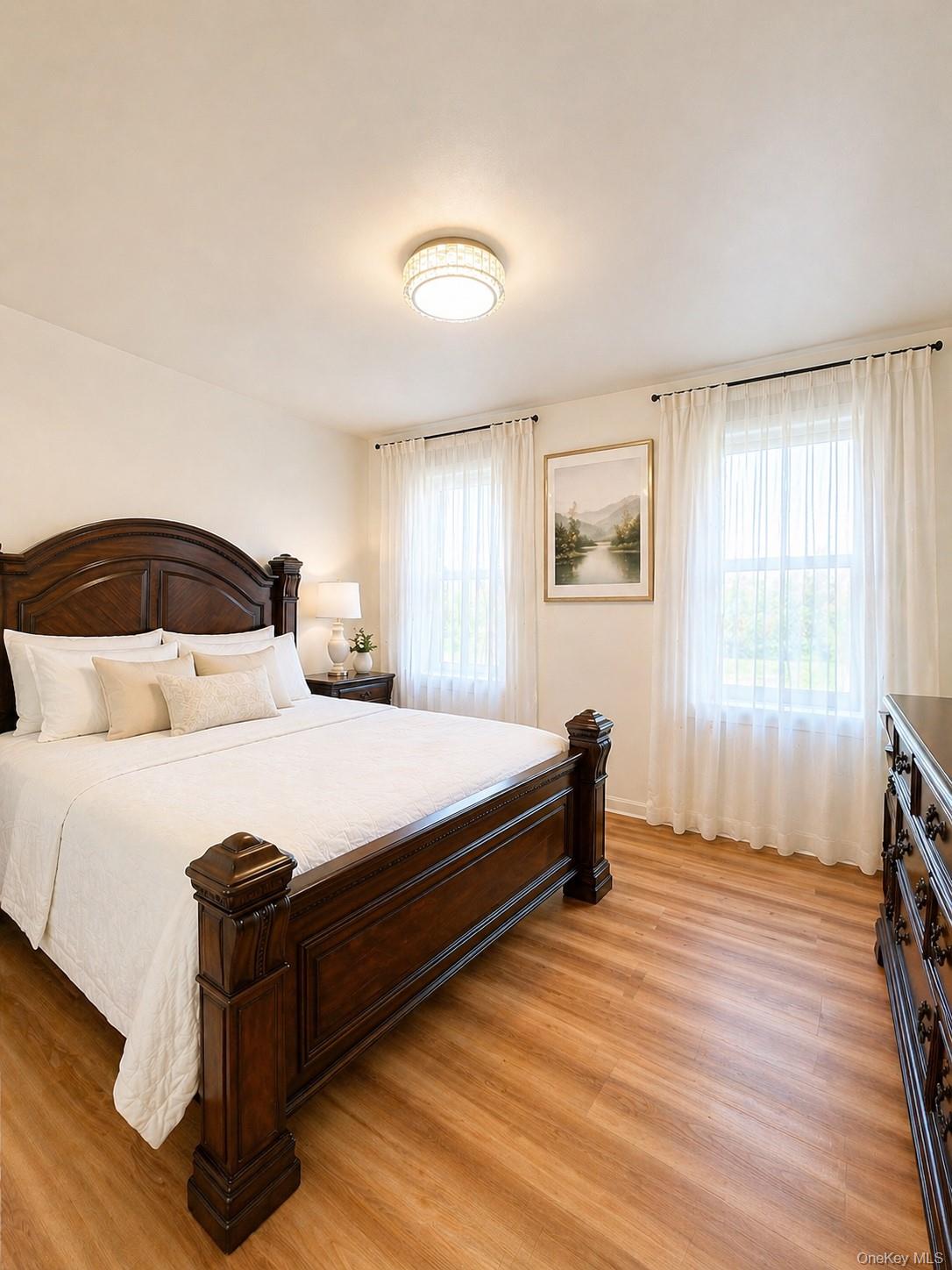 139-16 28th Road, Unit Z Queens, NY 11354 - Photo 4 of 14 a bedroom with a bed and wooden floor