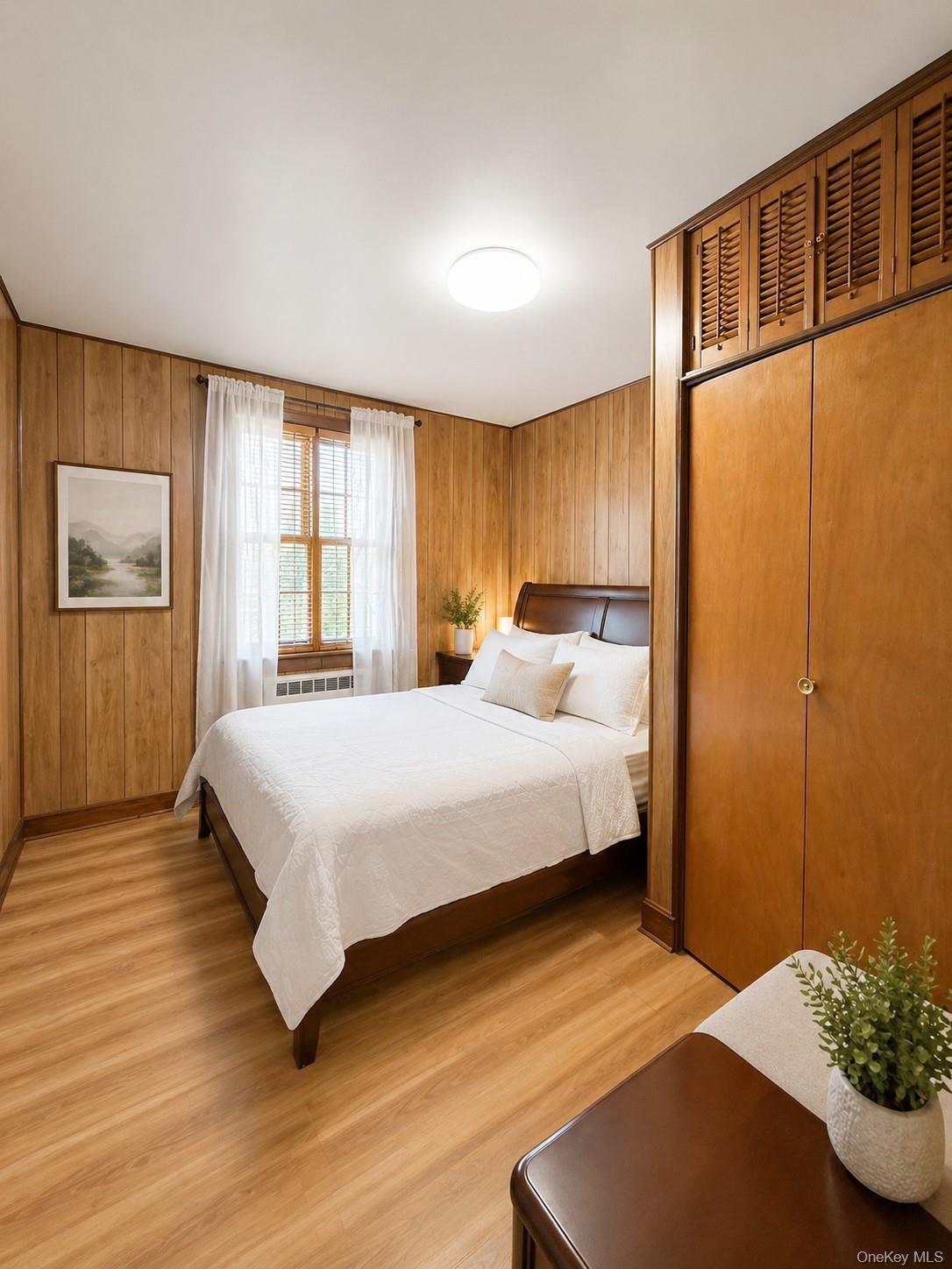 139-16 28th Road, Unit Z Queens, NY 11354 - Photo 7 of 14 a bedroom with a bed and wooden floor