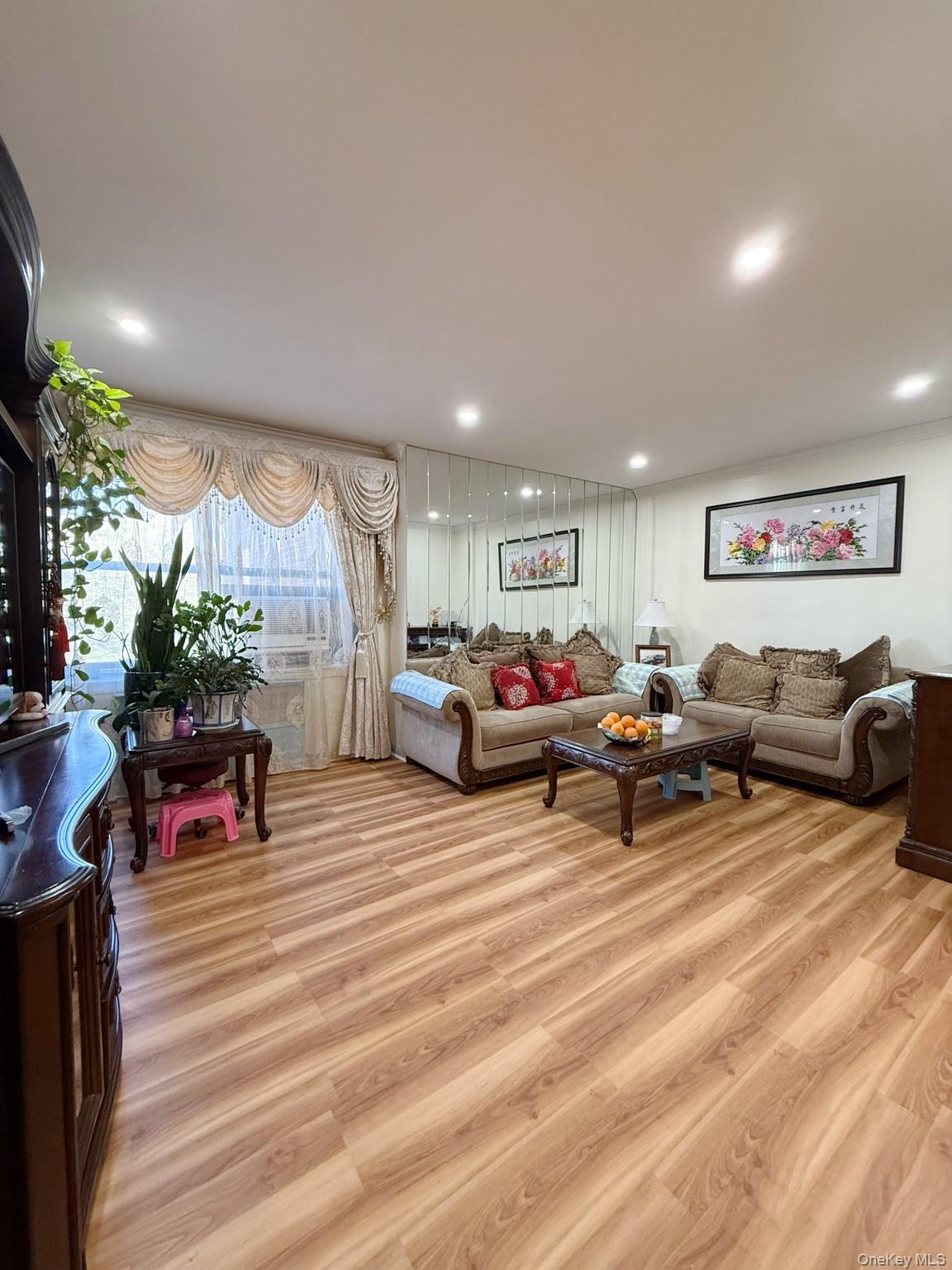 139-16 28th Road, Unit Z Queens, NY 11354 - Photo 10 of 14 a living room with furniture and a large window