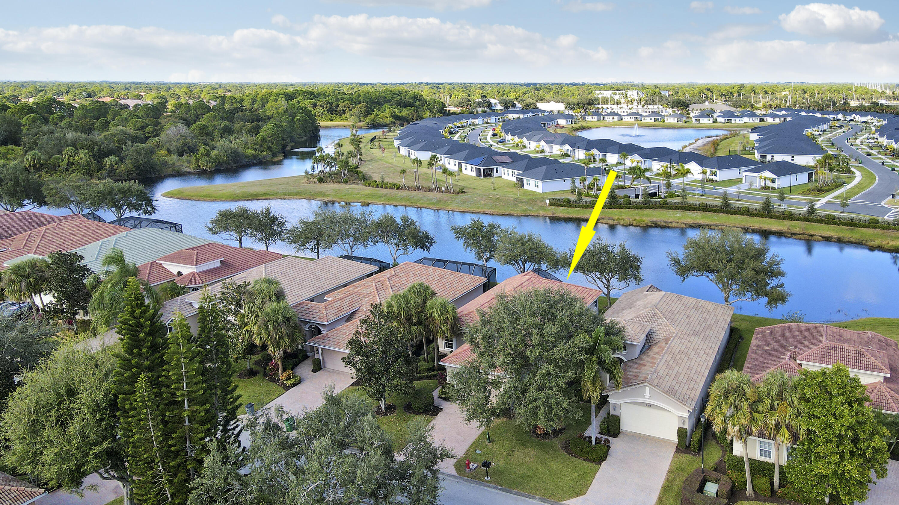9212 Short Chip Circle Port St. Lucie, FL 34986 - Photo 2 of 71 an aerial view of residential houses with outdoor space and lake view