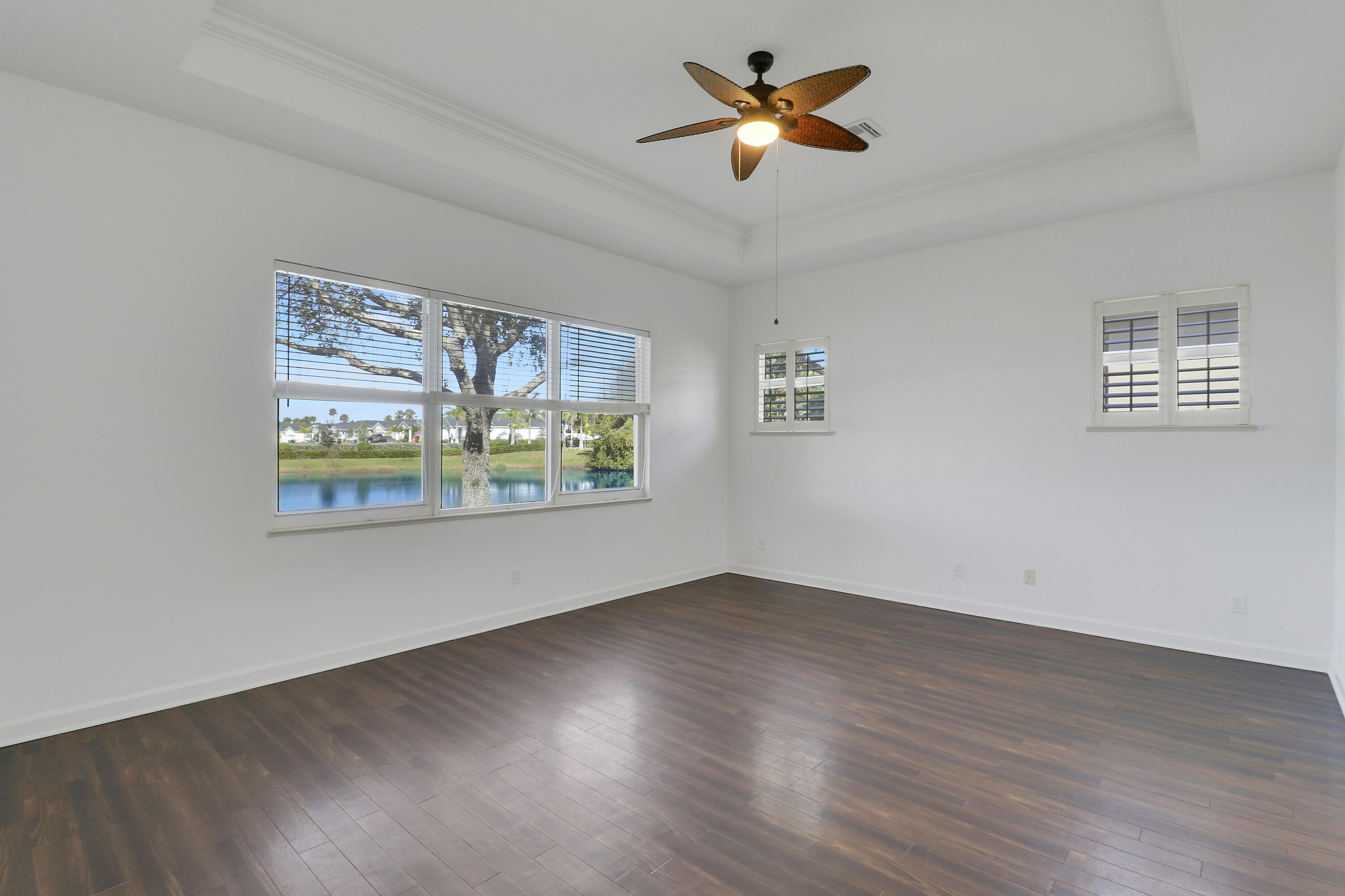 9212 Short Chip Circle Port St. Lucie, FL 34986 - Photo 23 of 71 a view of an empty room with window and wooden floor