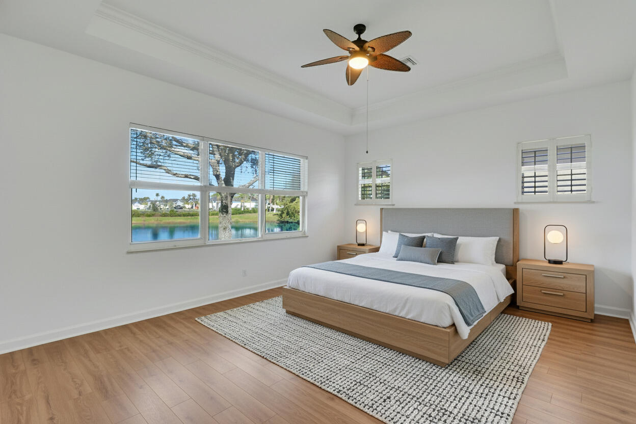 9212 Short Chip Circle Port St. Lucie, FL 34986 - Photo 25 of 71 a bedroom with a bed and a painting on the wall