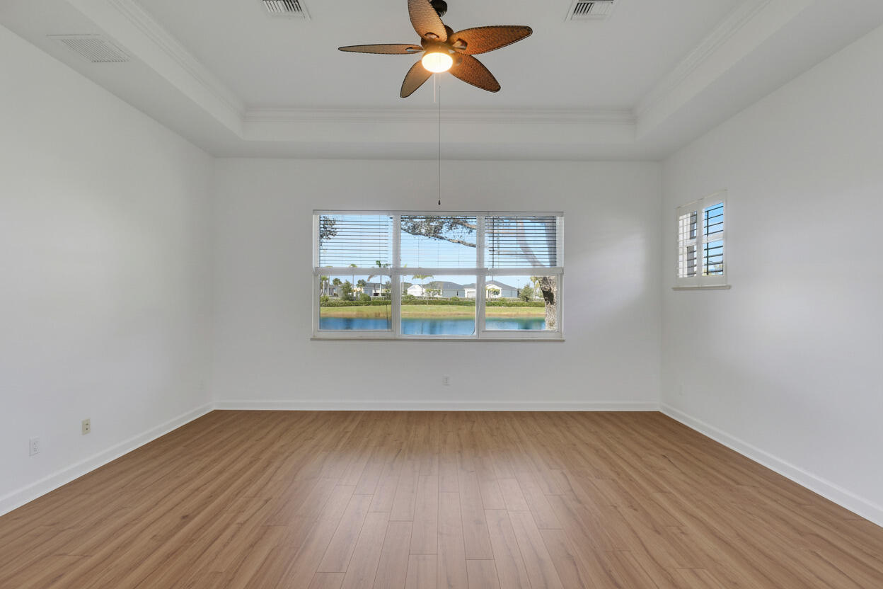 9212 Short Chip Circle Port St. Lucie, FL 34986 - Photo 27 of 71 a view of room with wooden floor and ceiling fan