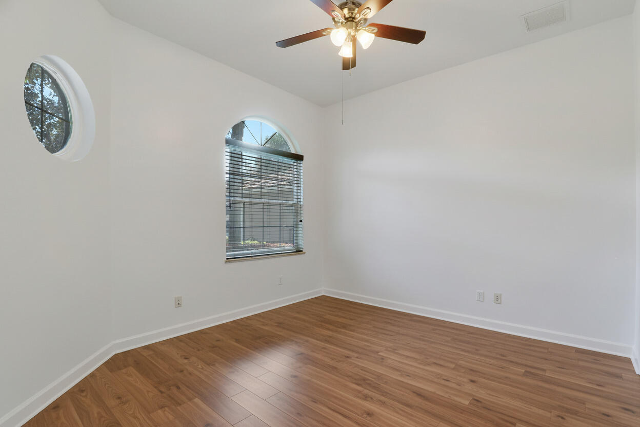 9212 Short Chip Circle Port St. Lucie, FL 34986 - Photo 37 of 71 an empty room with wooden floor and windows