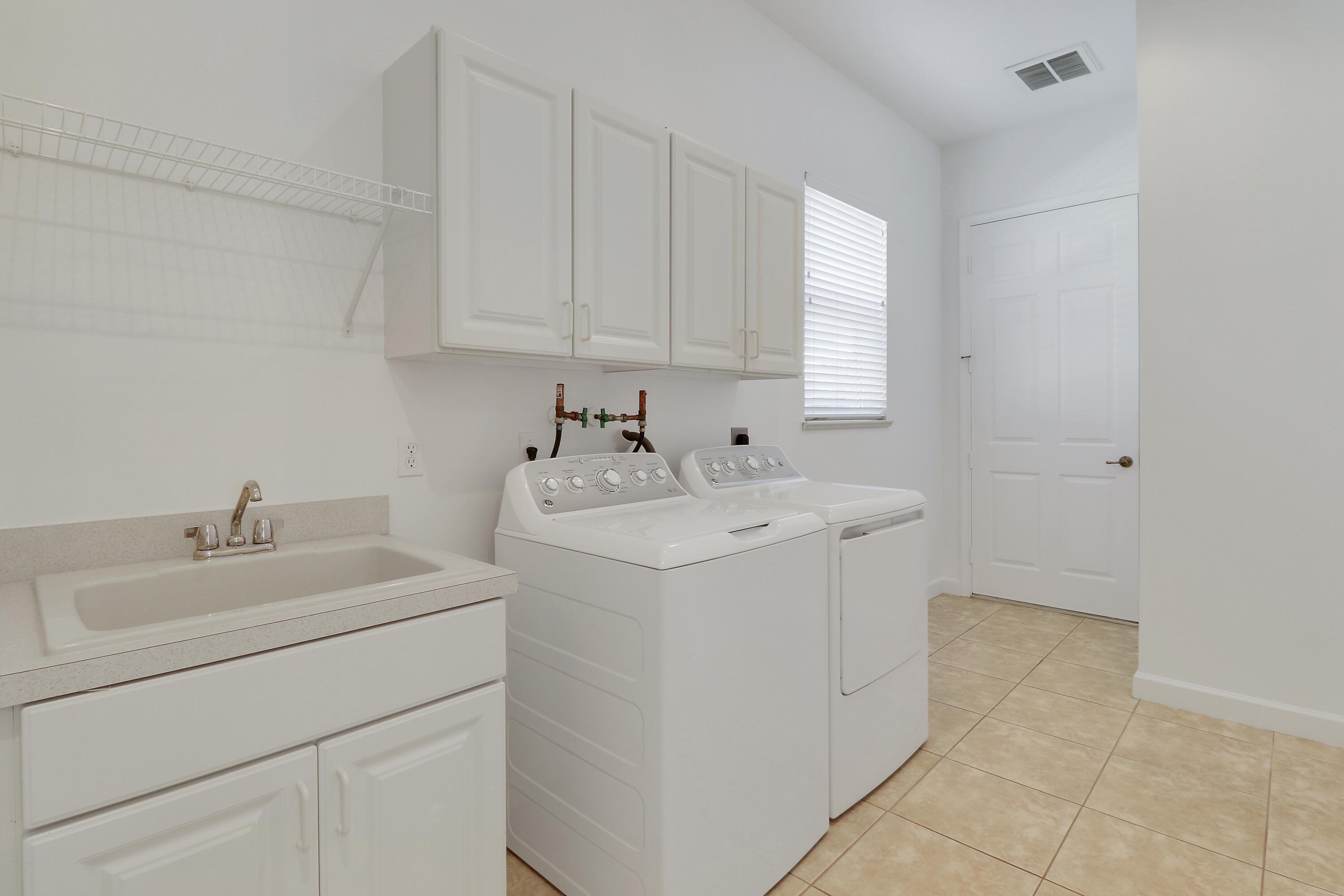 9212 Short Chip Circle Port St. Lucie, FL 34986 - Photo 39 of 71 a utility room with closet dryer and washer