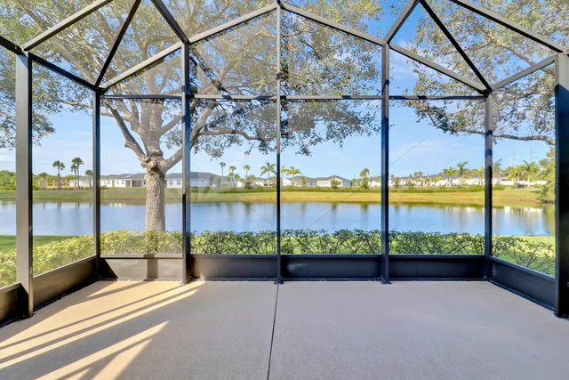 an empty room with fireplace and windows