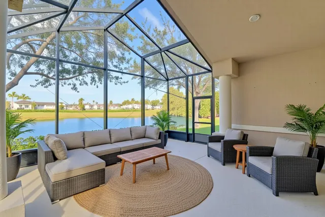 a living room with a bed and a flat screen tv