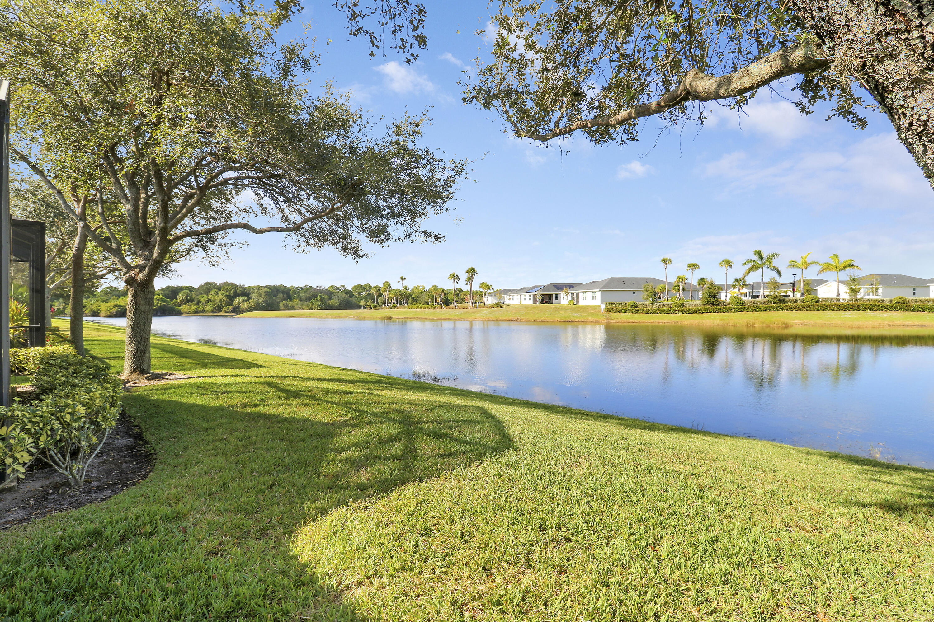 9212 Short Chip Circle Port St. Lucie, FL 34986 - Photo 45 of 71 a view of a lake with houses in the back