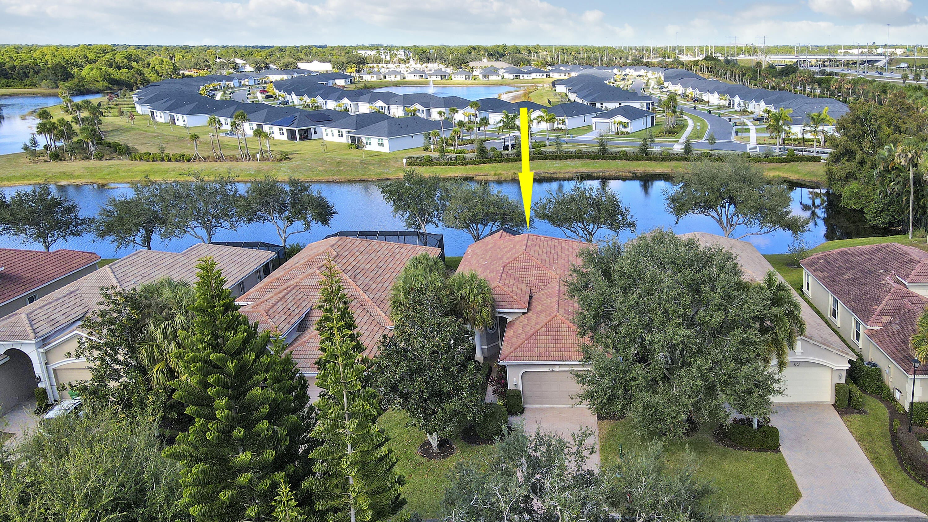 9212 Short Chip Circle Port St. Lucie, FL 34986 - Photo 48 of 71 an aerial view of a houses with outdoor space and lake view