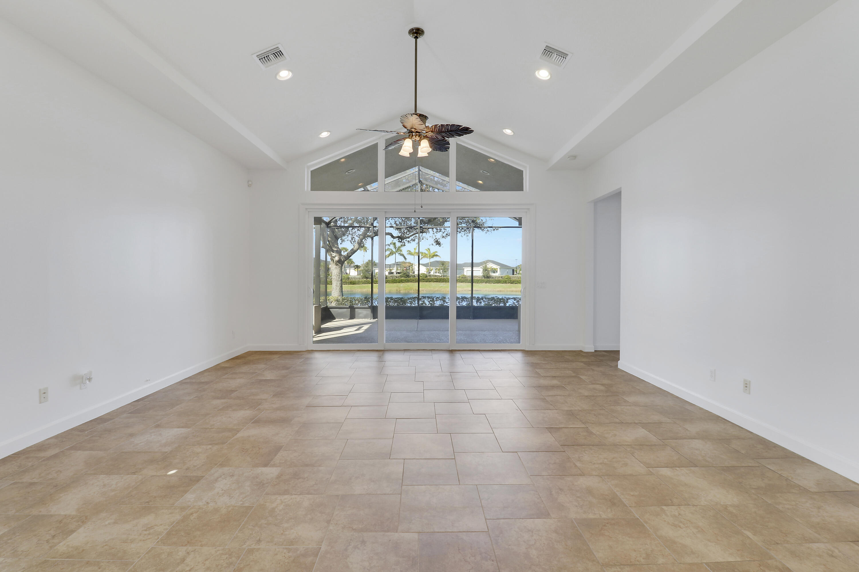 9212 Short Chip Circle Port St. Lucie, FL 34986 - Photo 6 of 71 an empty room with fireplace and windows