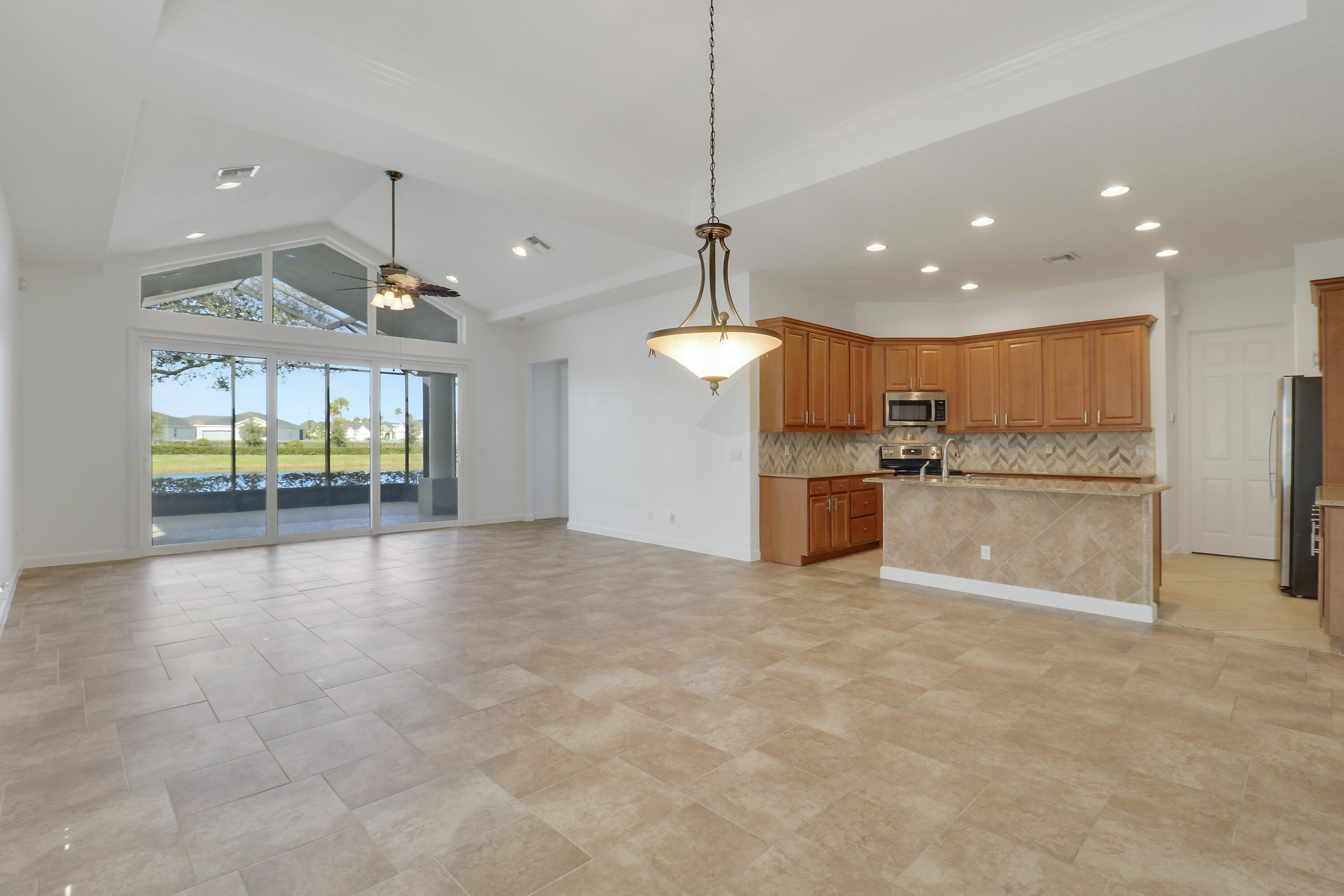 9212 Short Chip Circle Port St. Lucie, FL 34986 - Photo 8 of 71 a view of a kitchen with a sink and refrigerator