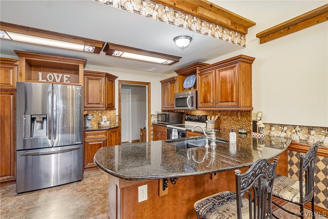 13816 Laurel Spring Road Chester, VA 23831 - Photo 13 of 31 a kitchen with stainless steel appliances granite countertop a sink a stove and a refrigerator