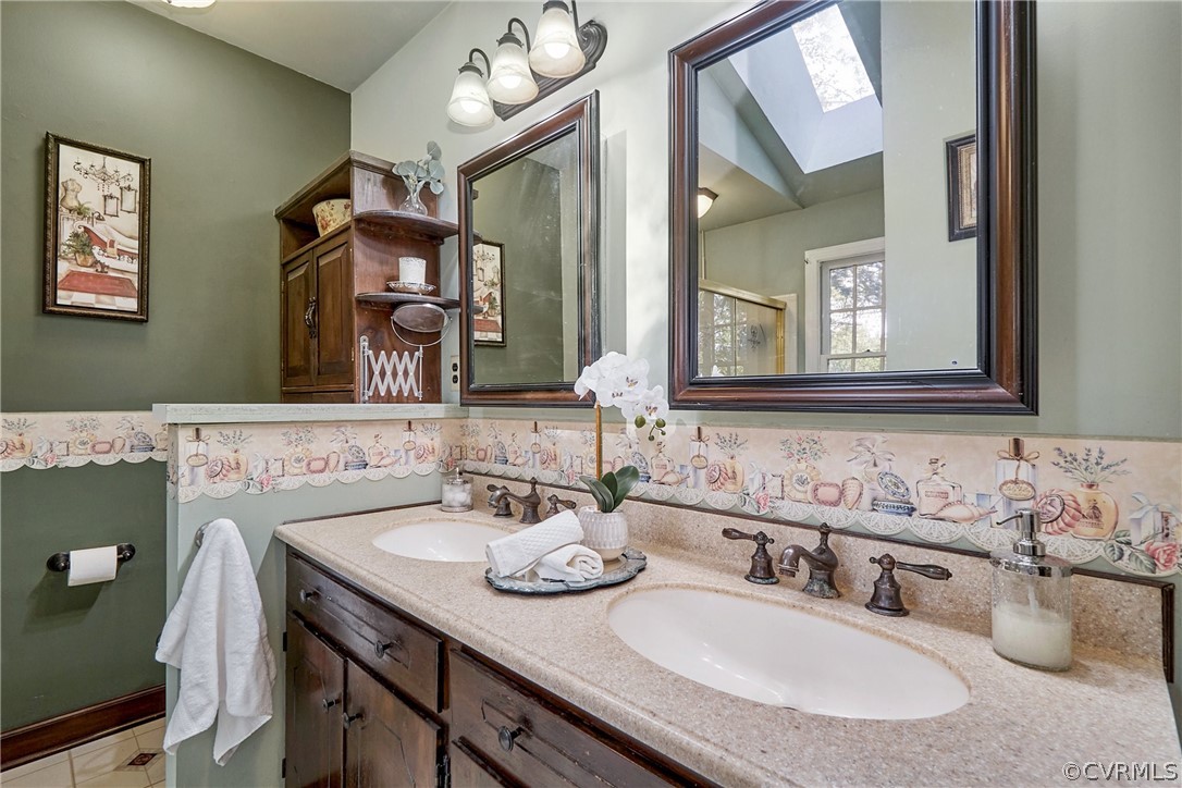 13816 Laurel Spring Road Chester, VA 23831 - Photo 18 of 31 a bathroom with a sink double vanity and a mirror
